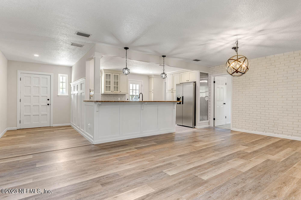 4066 Ferrarra Street Jacksonville, FL 32217 - Photo 5 of 25 a view of a kitchen with wooden floor and a window
