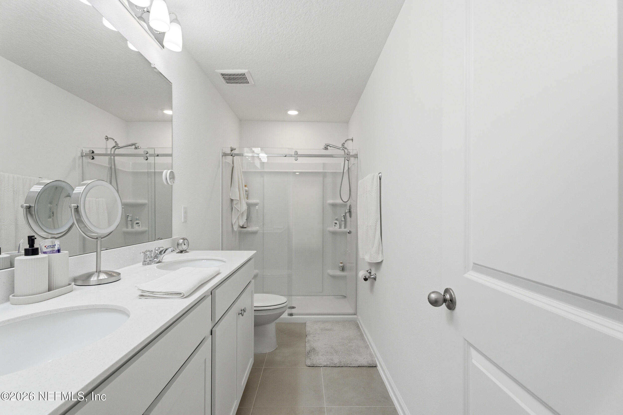 1615 Cluny Road Jacksonville, FL 32218 - Photo 11 of 18 a bathroom with a double vanity sink mirror and shower
