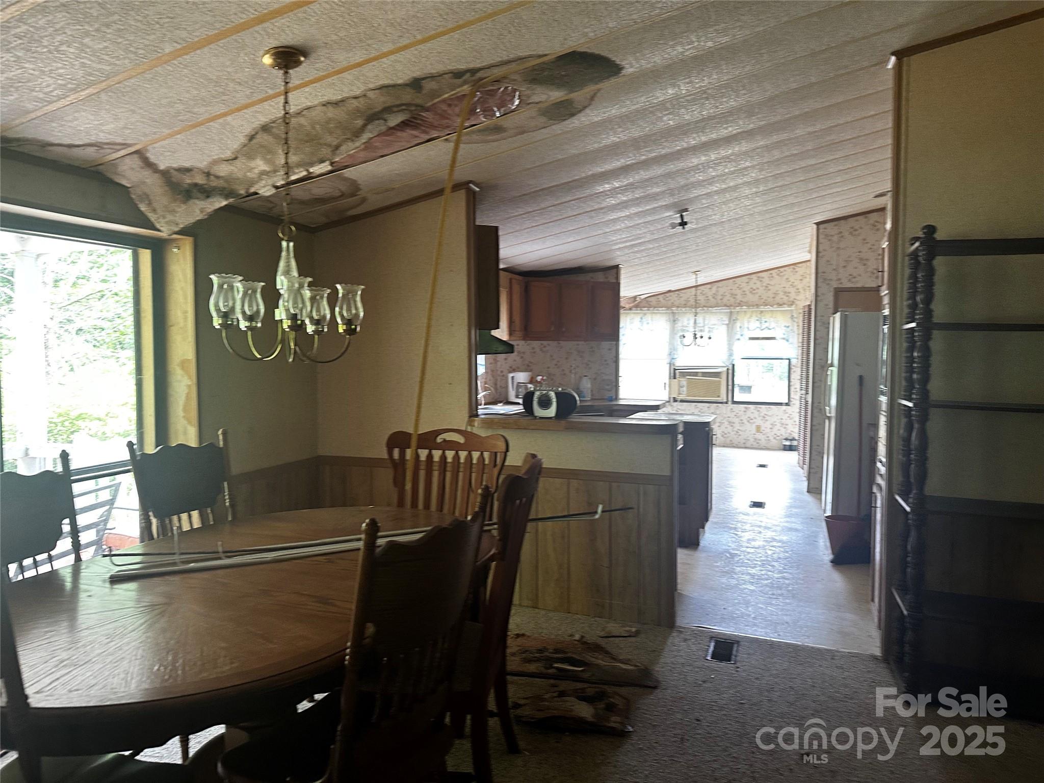 731 Pigeon Roost Road Green Mountain, NC 28740 - Photo 15 of 31 a kitchen with a table chairs and refrigerator
