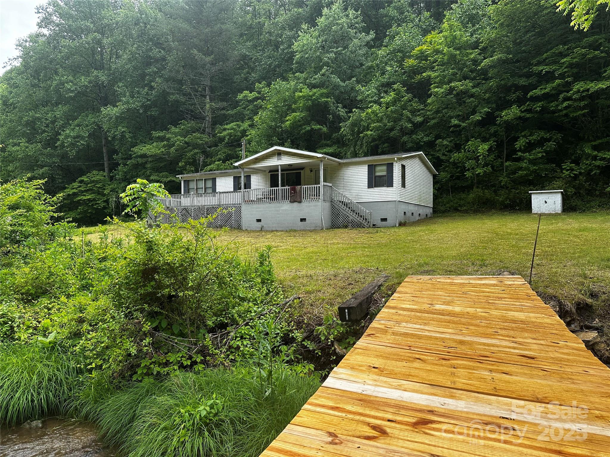 731 Pigeon Roost Road Green Mountain, NC 28740 - Photo 21 of 31 a front view of a house with a yard