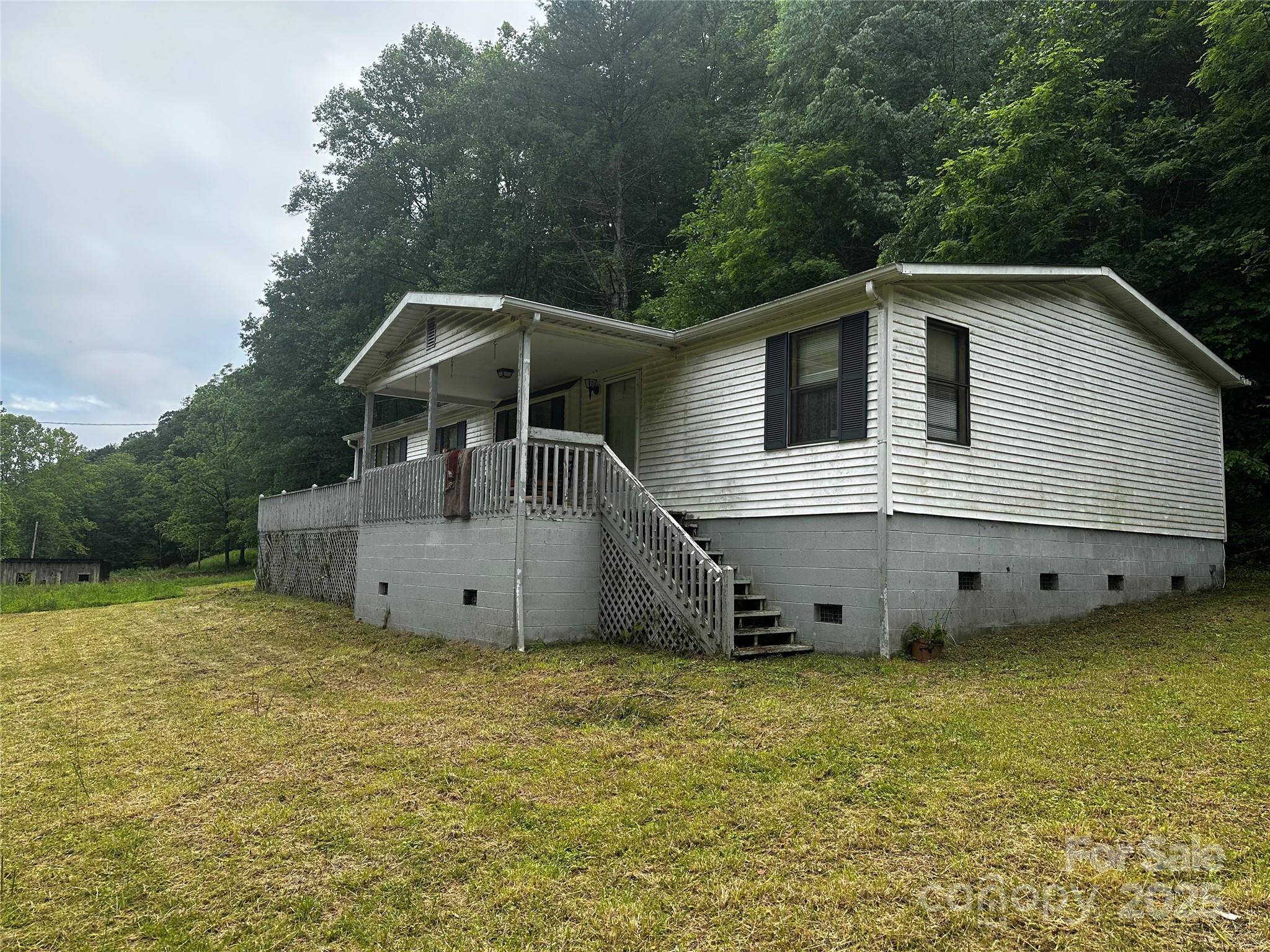 731 Pigeon Roost Road Green Mountain, NC 28740 - Photo 28 of 31 a house with trees in the background
