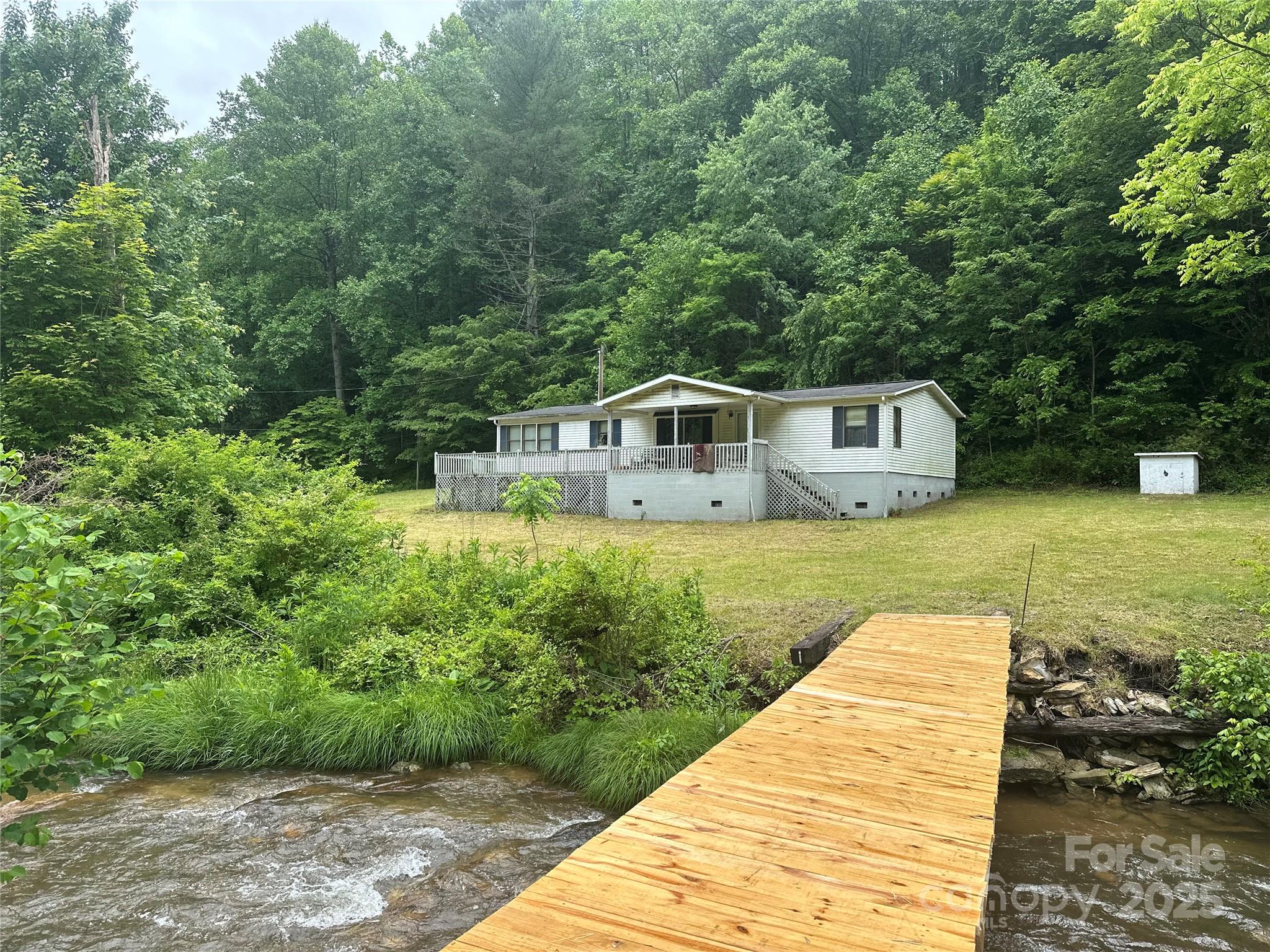 731 Pigeon Roost Road Green Mountain, NC 28740 - Photo 29 of 31 a view of a house with a yard
