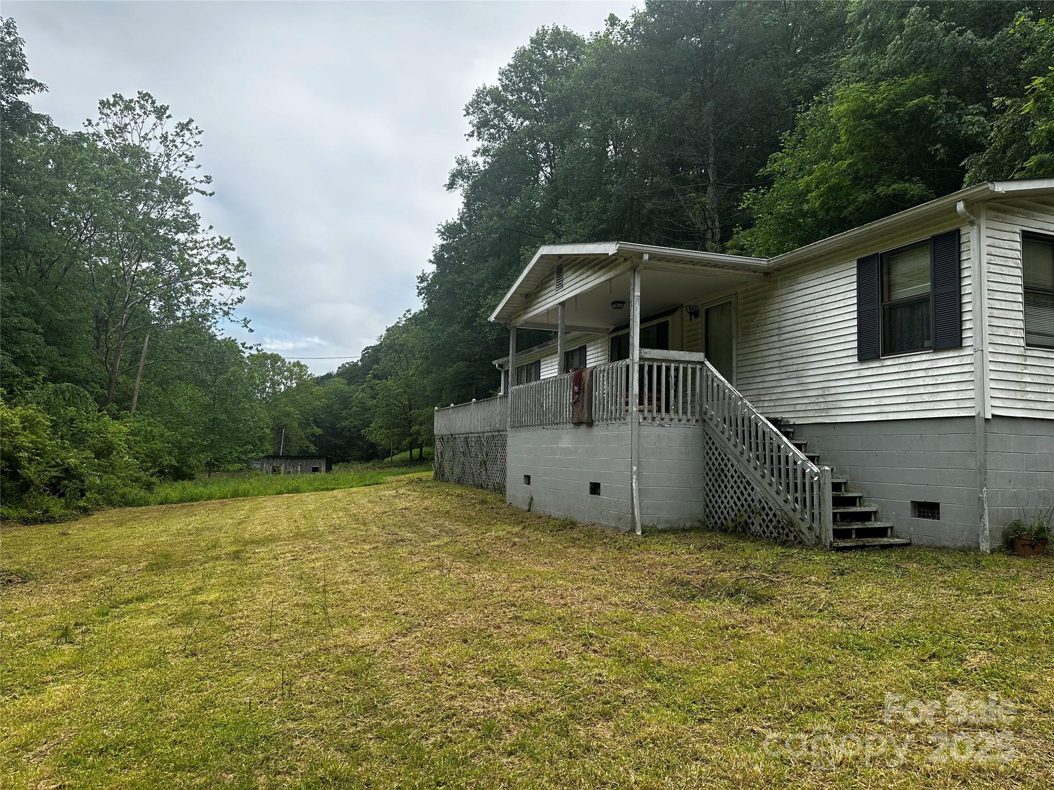 731 Pigeon Roost Road Green Mountain, NC 28740 - Photo 31 of 31 a house with trees in the background