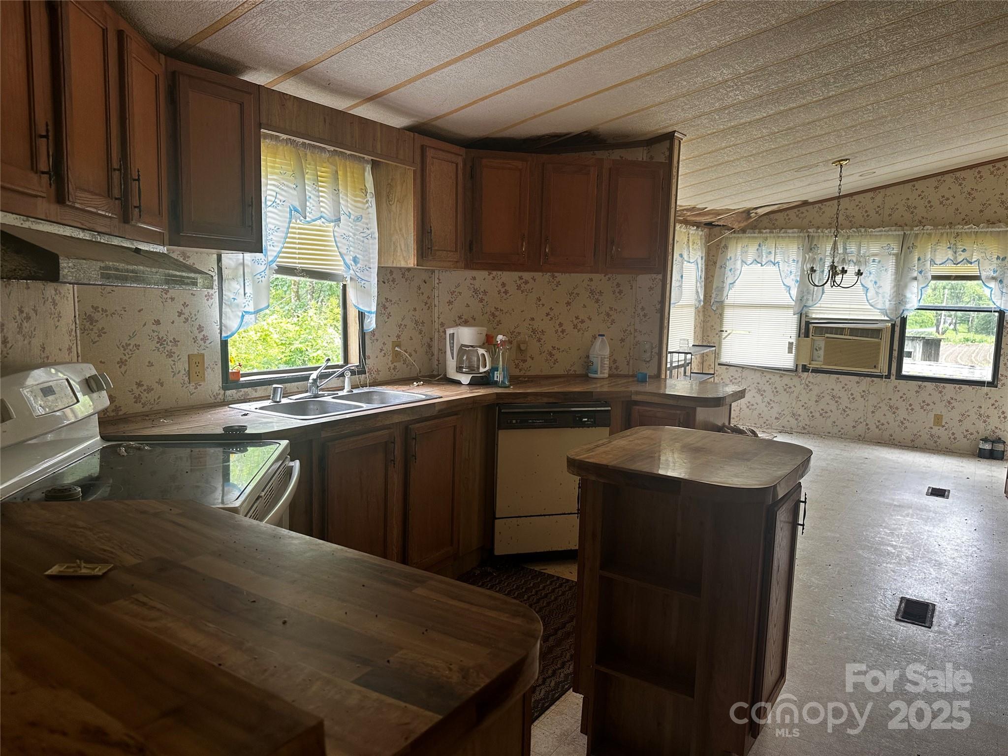 731 Pigeon Roost Road Green Mountain, NC 28740 - Photo 5 of 31 a kitchen with a sink a stove a window cabinets and a counter top space