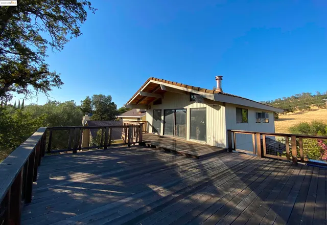 a view of a house with wooden fence