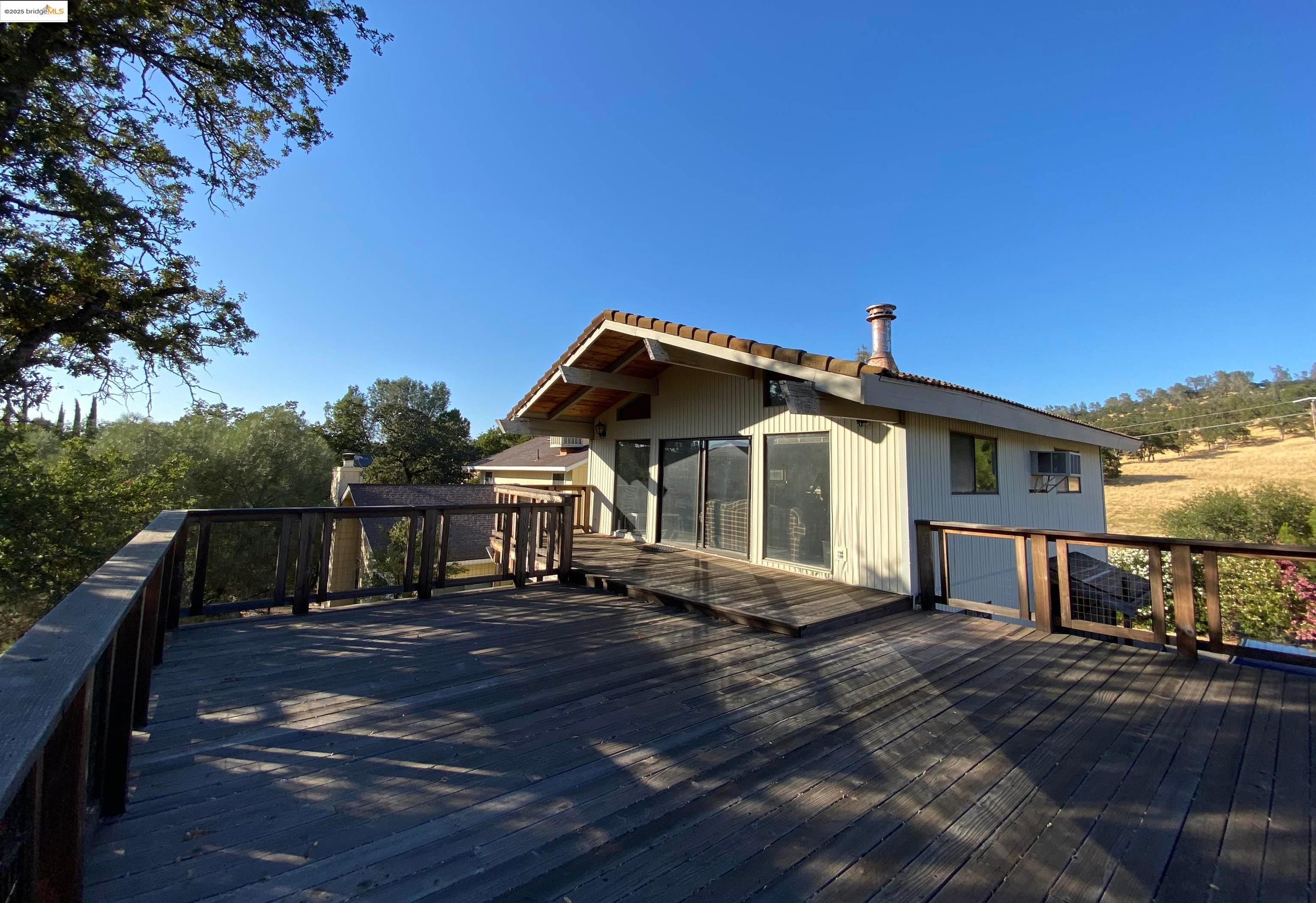a view of a house with wooden fence