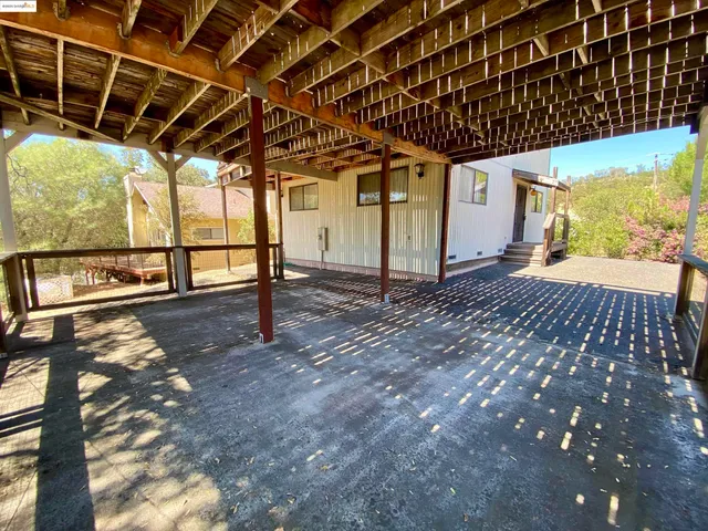 a view of a porch with a wooden bench
