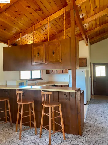 a room with stainless steel appliances kitchen island granite countertop furniture and a sink