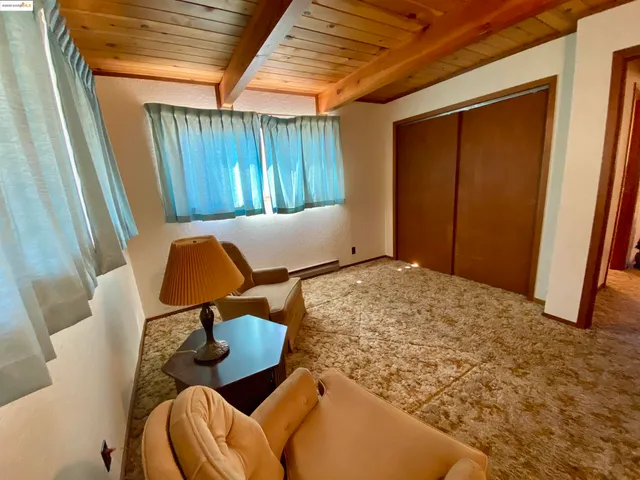 a bedroom with furniture and a window