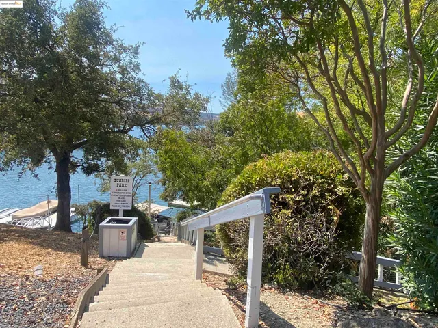 a sign board with yard in the back