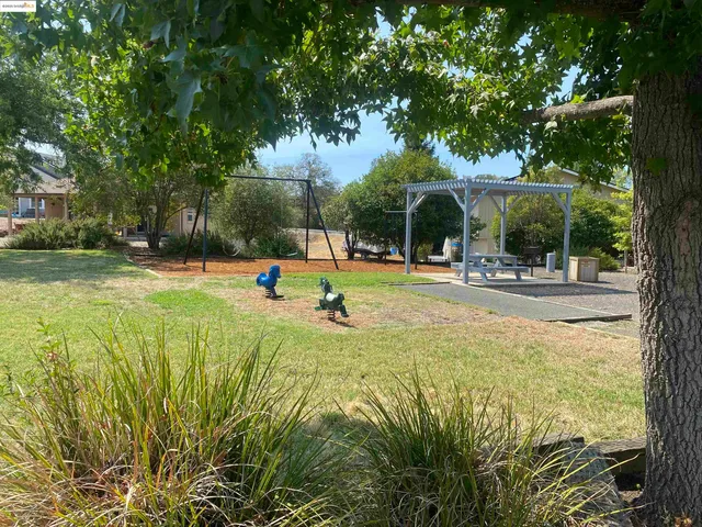 a view of a park with swings and slides