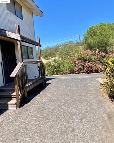 a view of backyard with hardwood and deck
