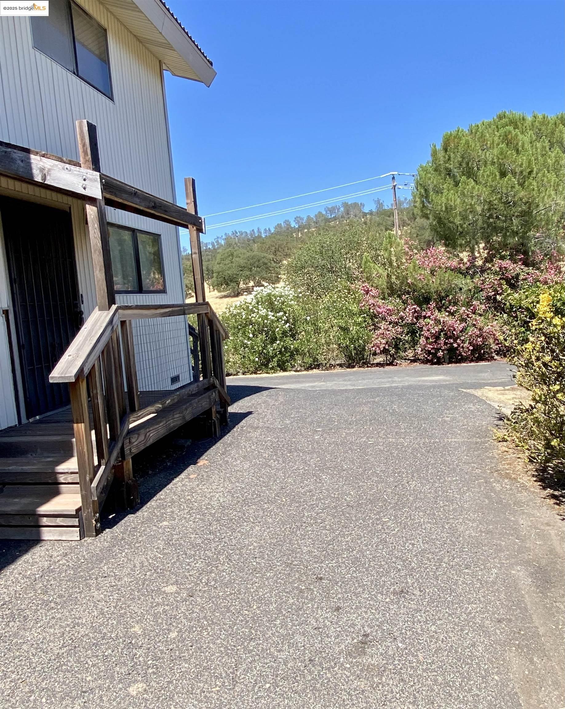 75 Poker Flat Road Copperopolis, CA 95228 - Photo 6 of 50 a view of backyard with hardwood and deck