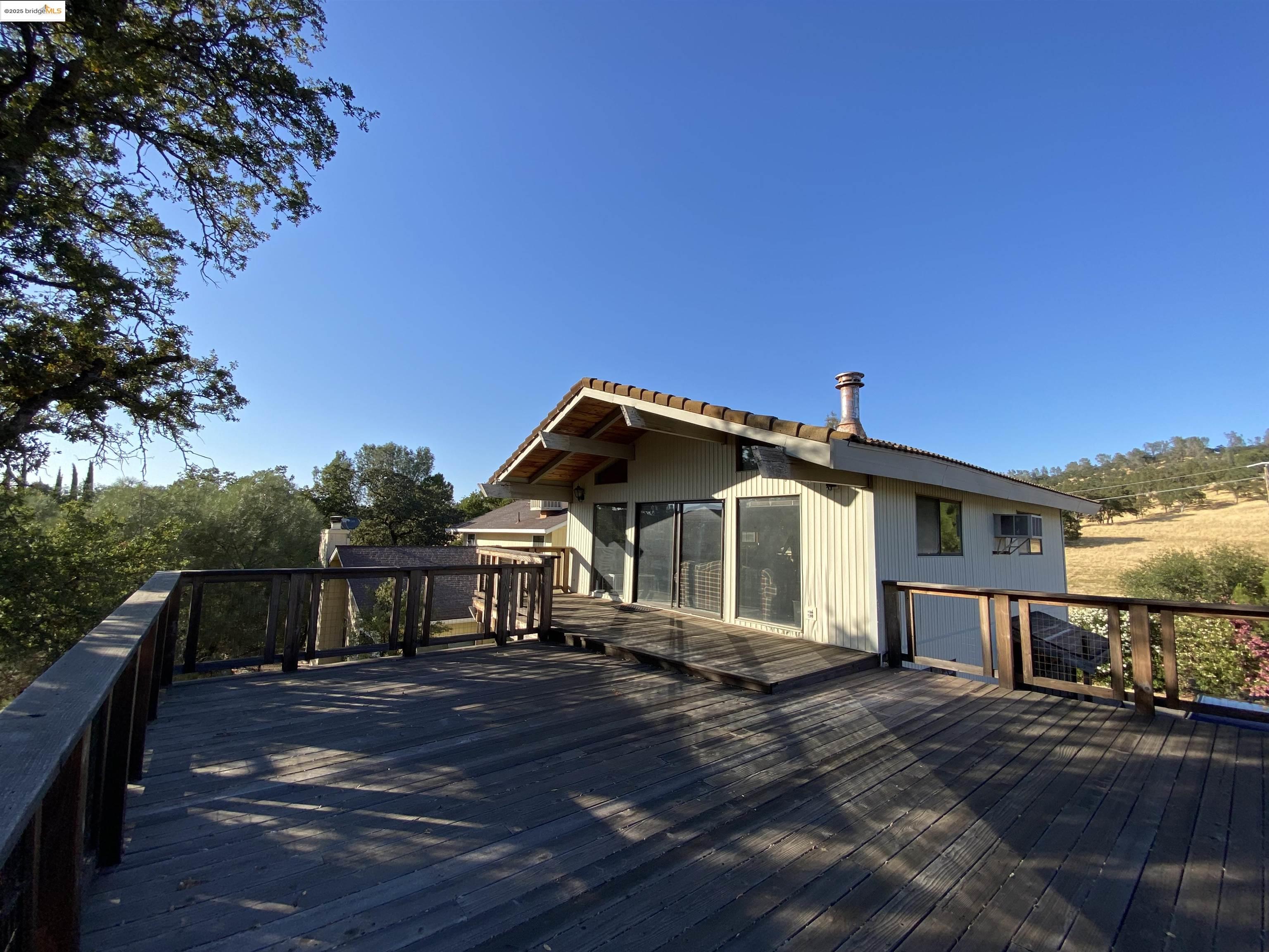 75 Poker Flat Road Copperopolis, CA 95228 - Photo 10 of 50 a front view of a house with yard and balcony