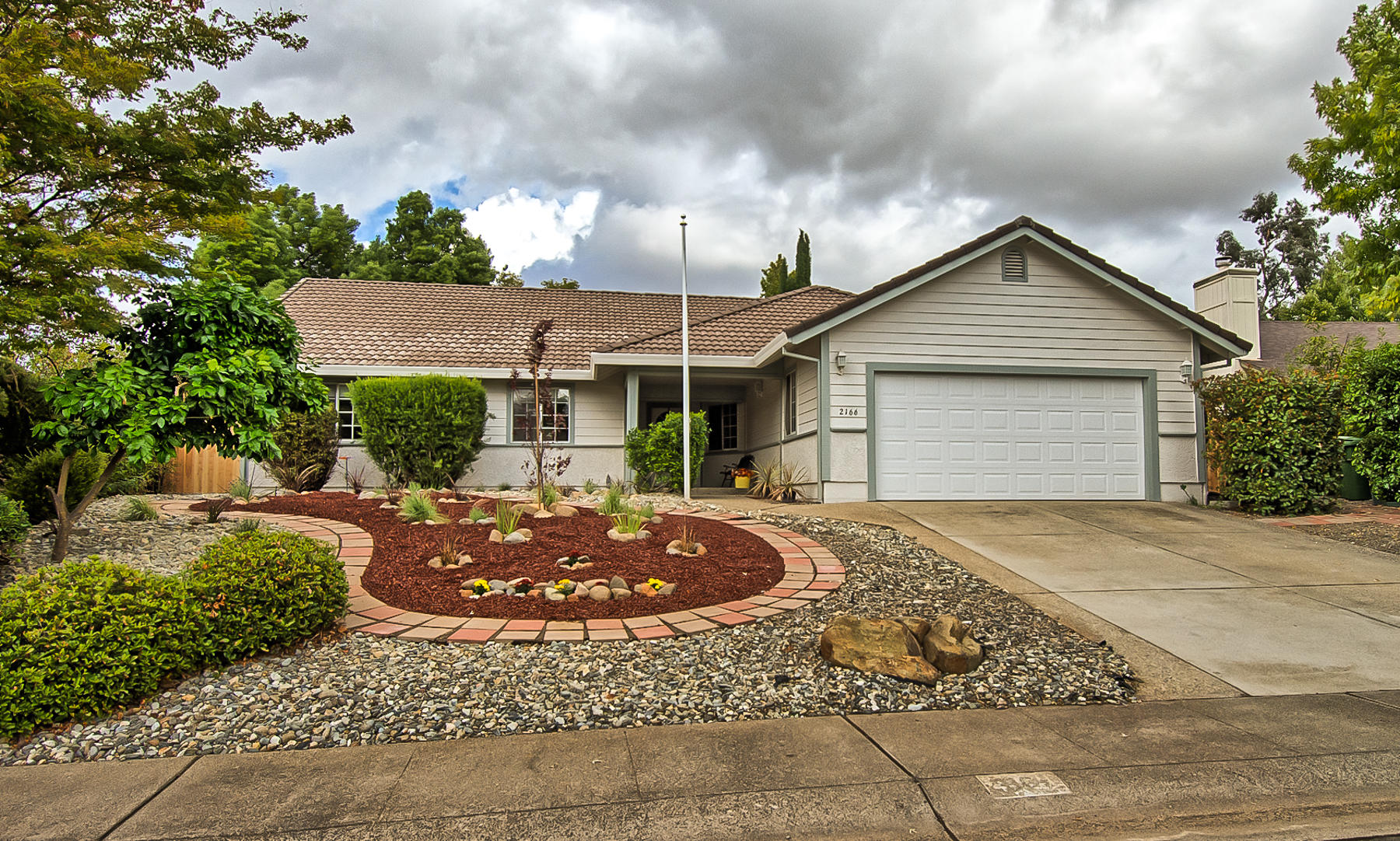 a front view of a house with garden