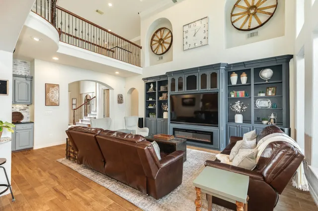 a living room with furniture a flat screen tv and a fireplace