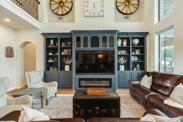 a kitchen with stainless steel appliances a dining table chairs and wooden floor