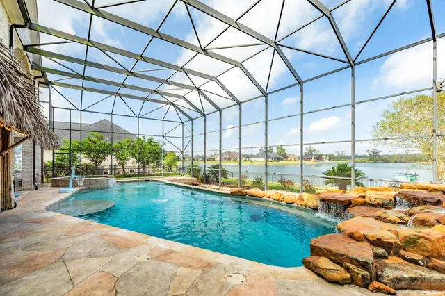 a kitchen with a stove and a view of living room