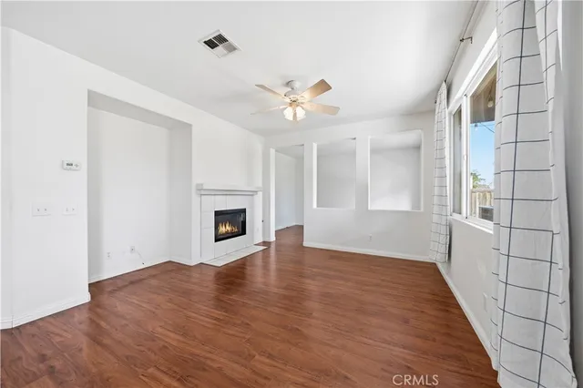 an empty room with windows and a fireplace