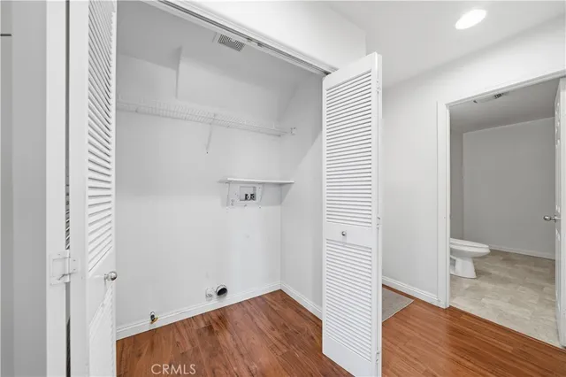 a view of hallway with wooden floor