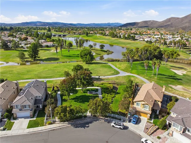 an aerial view of a city with lots of residential buildings and mountain view in back