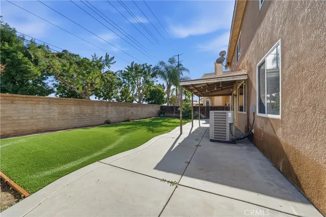 a view of backyard with outdoor seating and green space