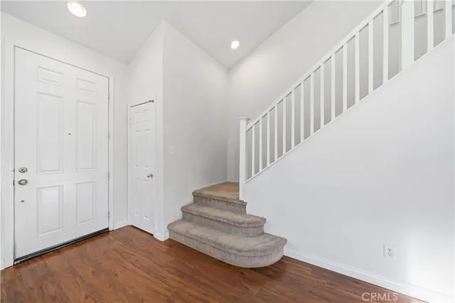 a view of entryway and hall with wooden floor
