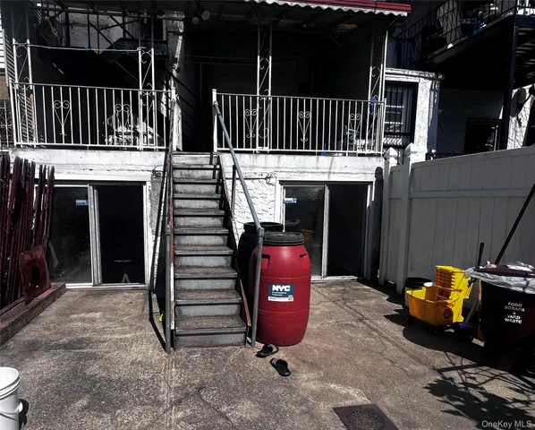 a view of a patio with table and chairs with wooden floor and fence