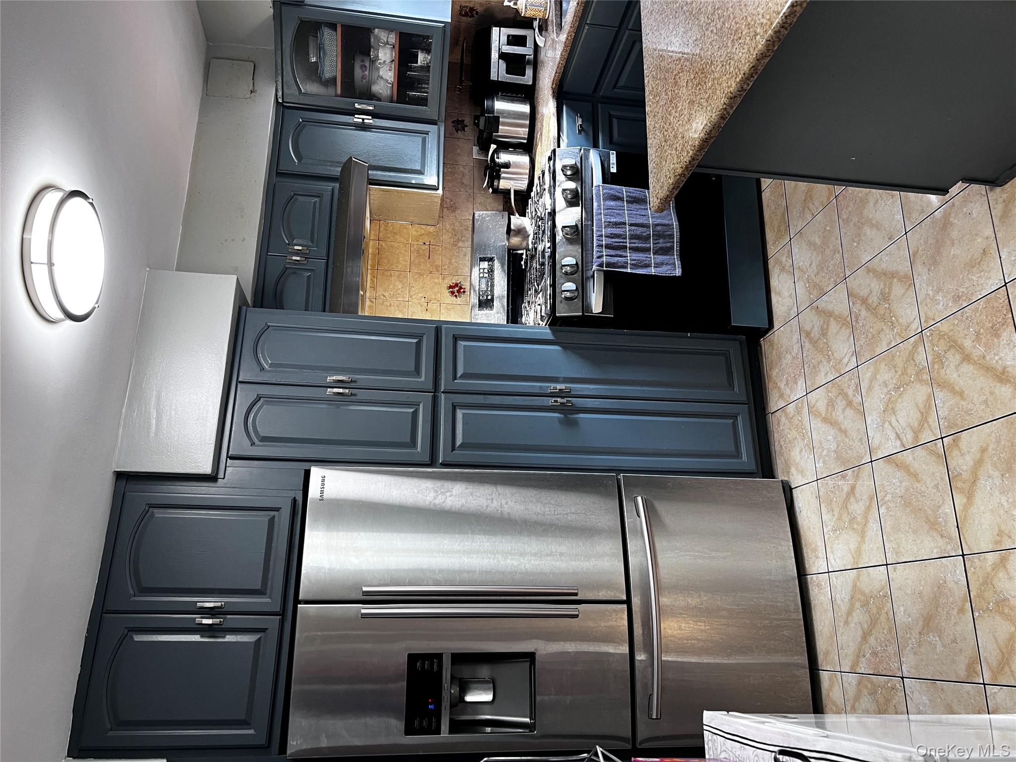 4153 Bruner Avenue Bronx, NY 10466 - Photo 4 of 13 a kitchen with stainless steel appliances granite countertop a refrigerator stove and microwave