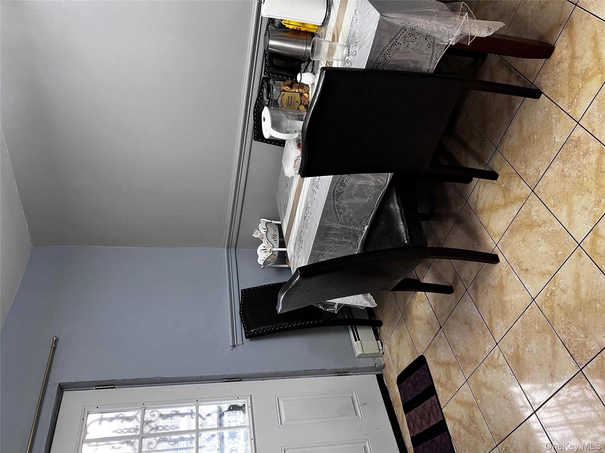 4153 Bruner Avenue Bronx, NY 10466 - Photo 5 of 13 a room with a table chairs and a window