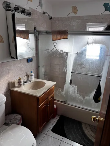 a bathroom with a sink mirror vanity and toilet