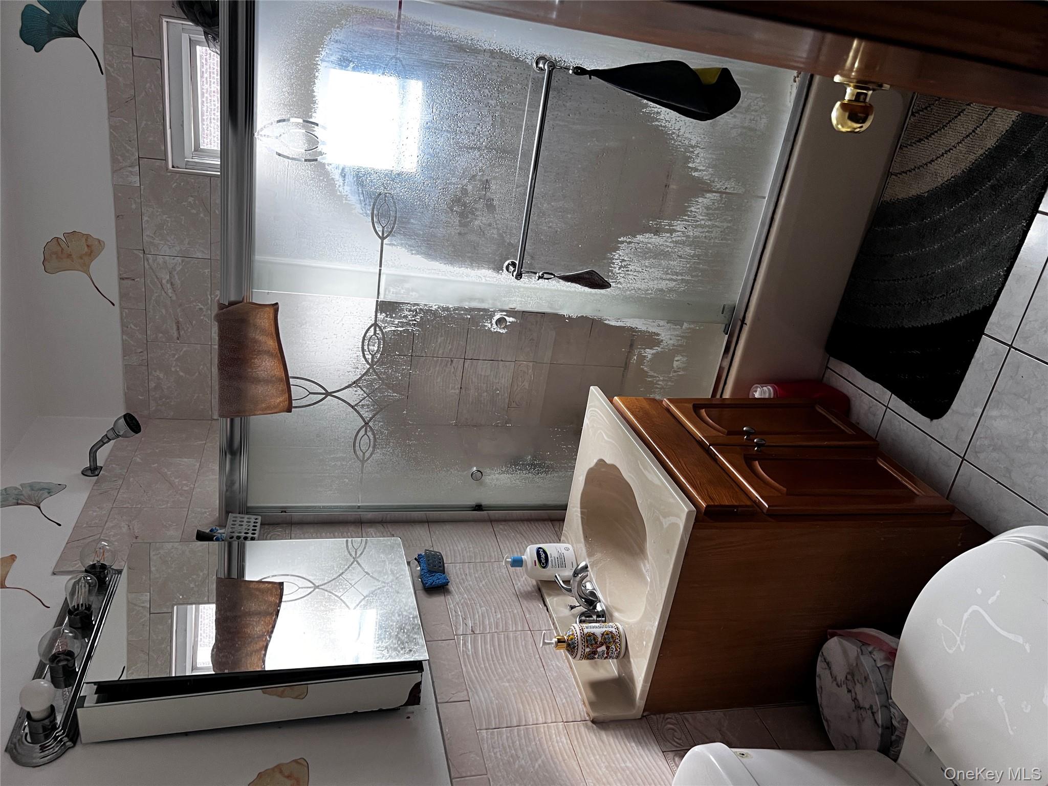 4153 Bruner Avenue Bronx, NY 10466 - Photo 7 of 13 a bathroom with a sink mirror vanity and toilet