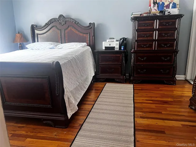 a bedroom with a bed and dresser