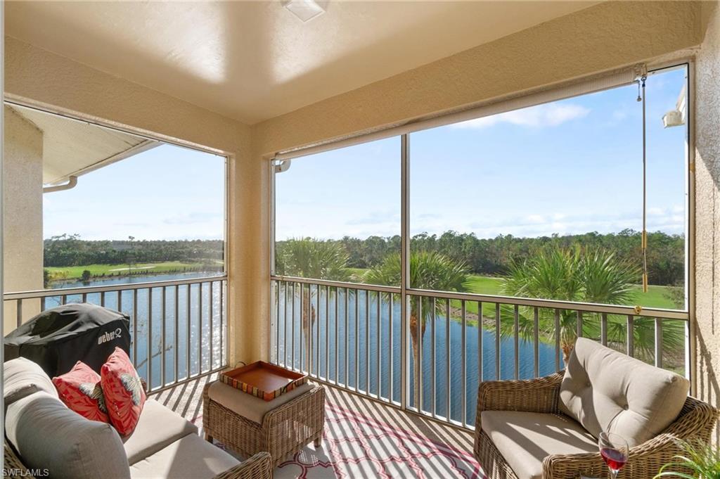 a balcony with wooden floor table and chairs
