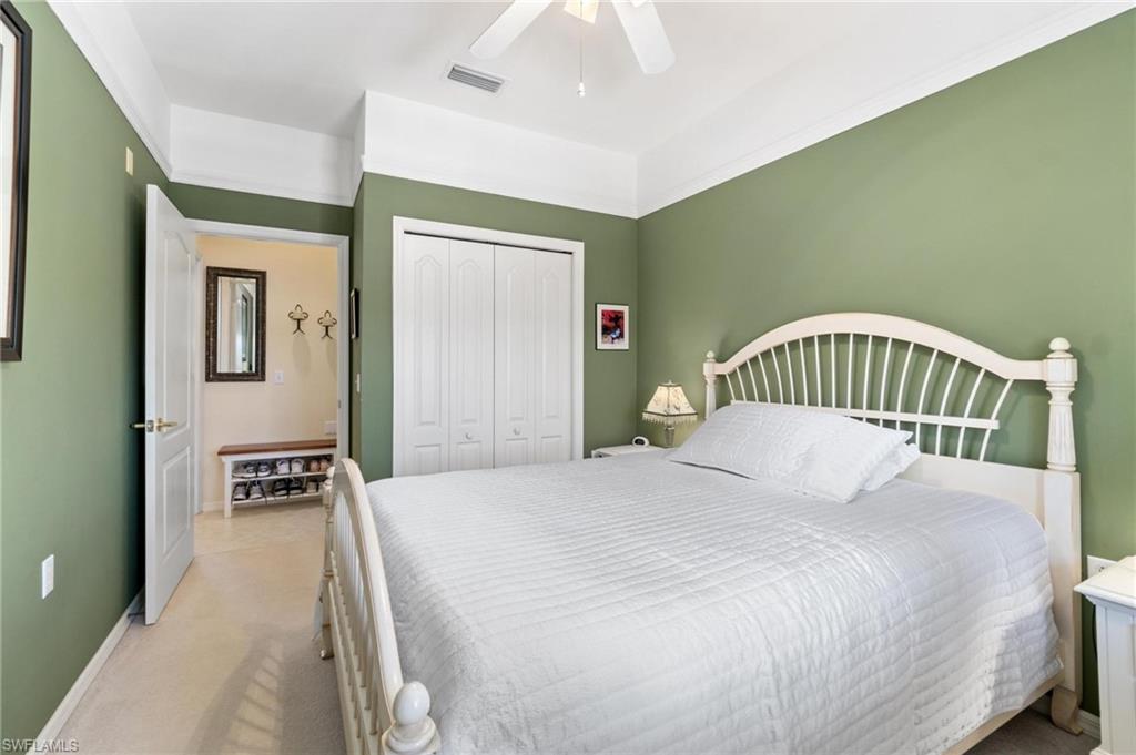 8610 Cedar Hammock Circle, Unit 1242 Naples, FL 34112 - Photo 11 of 50 a bedroom with a bed and wooden floor