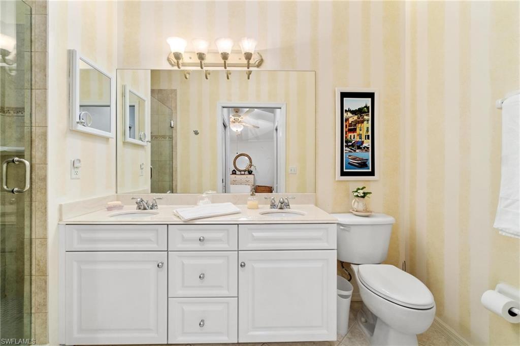 8610 Cedar Hammock Circle, Unit 1242 Naples, FL 34112 - Photo 15 of 50 a bathroom with a toilet sink and mirror