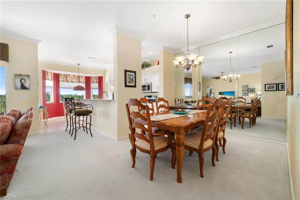 8610 Cedar Hammock Circle, Unit 1242 Naples, FL 34112 - Photo 19 of 50 a view of a dining room with furniture