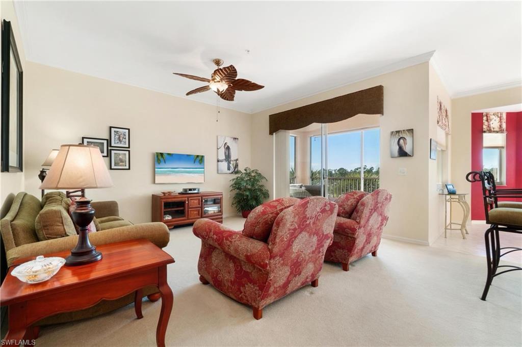 8610 Cedar Hammock Circle, Unit 1242 Naples, FL 34112 - Photo 21 of 50 a living room with furniture and a wooden floor