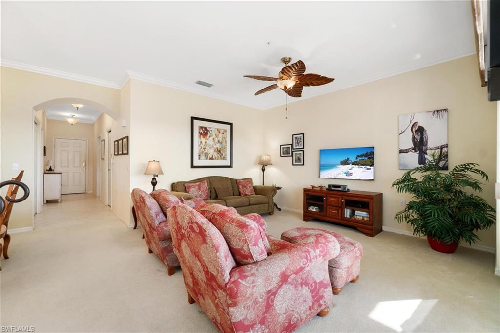 8610 Cedar Hammock Circle, Unit 1242 Naples, FL 34112 - Photo 23 of 50 a living room with furniture and a flat screen tv
