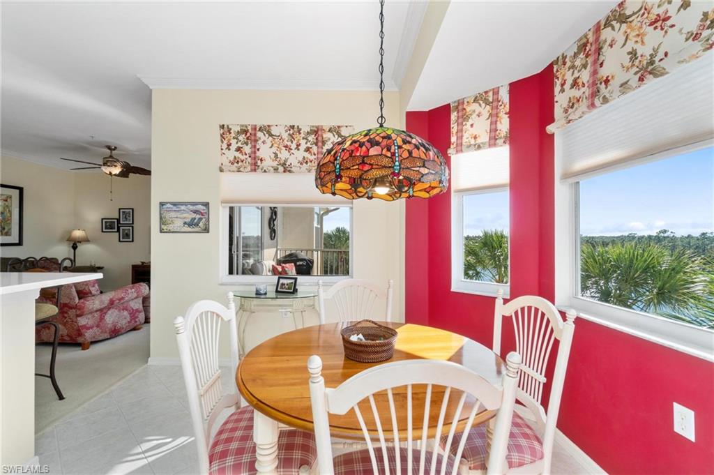 8610 Cedar Hammock Circle, Unit 1242 Naples, FL 34112 - Photo 29 of 50 a view of a dining room with furniture a chandelier and a large window