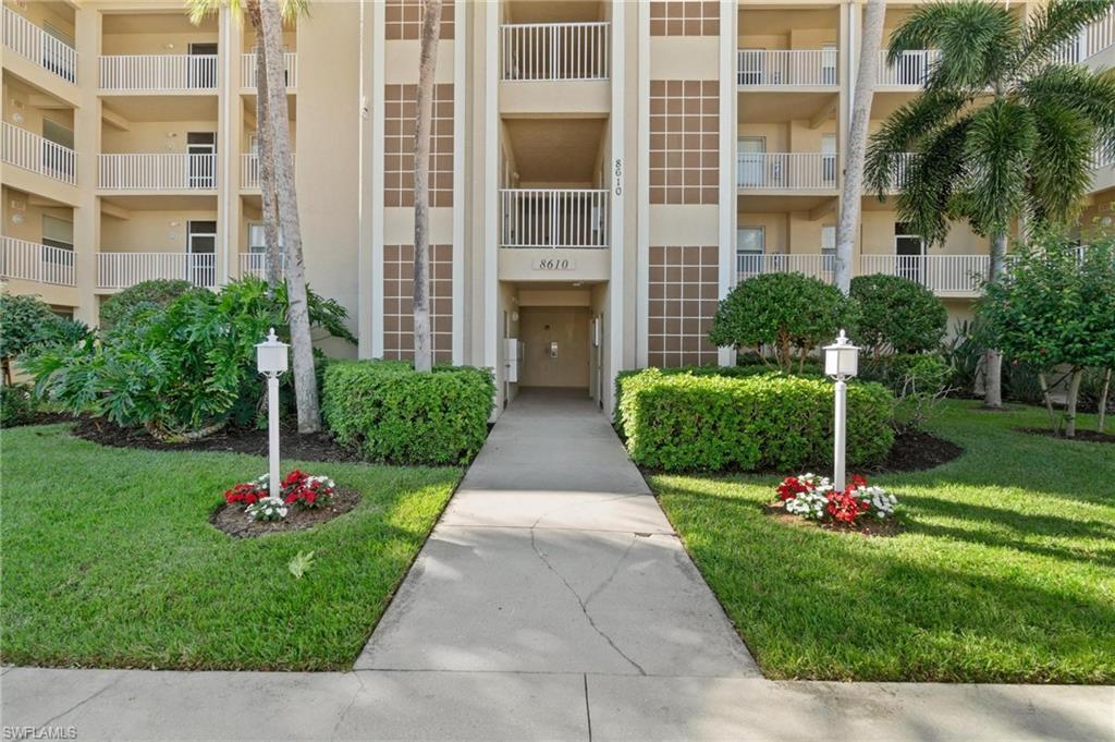8610 Cedar Hammock Circle, Unit 1242 Naples, FL 34112 - Photo 4 of 50 a front view of building with yard