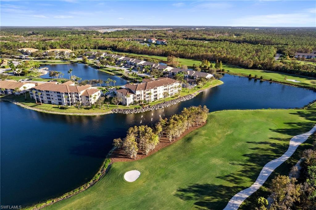8610 Cedar Hammock Circle, Unit 1242 Naples, FL 34112 - Photo 41 of 50 an aerial view of a house with a lake view