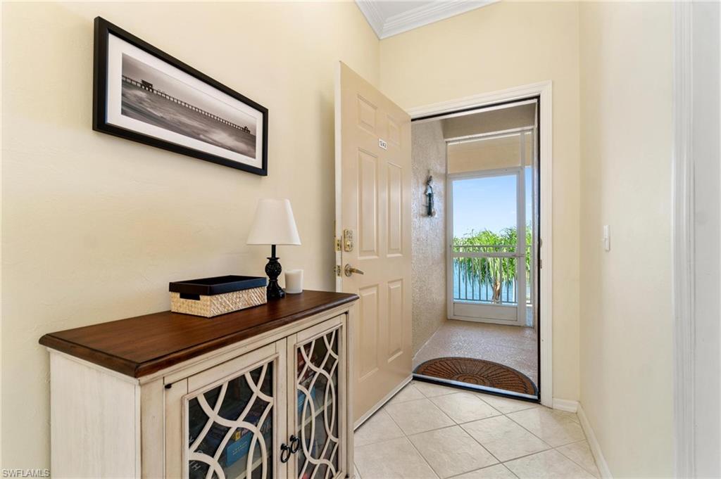 8610 Cedar Hammock Circle, Unit 1242 Naples, FL 34112 - Photo 8 of 50 a kitchen with stainless steel appliances a stove a microwave and a potted plant
