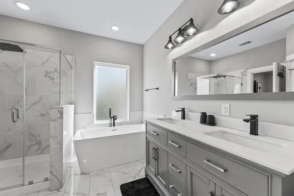a bathroom with a sink double vanity and shower