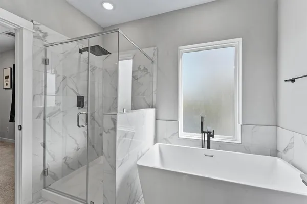 a bathroom with a bathtub and a shower