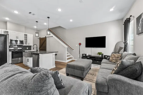 a living room with furniture and a flat screen tv