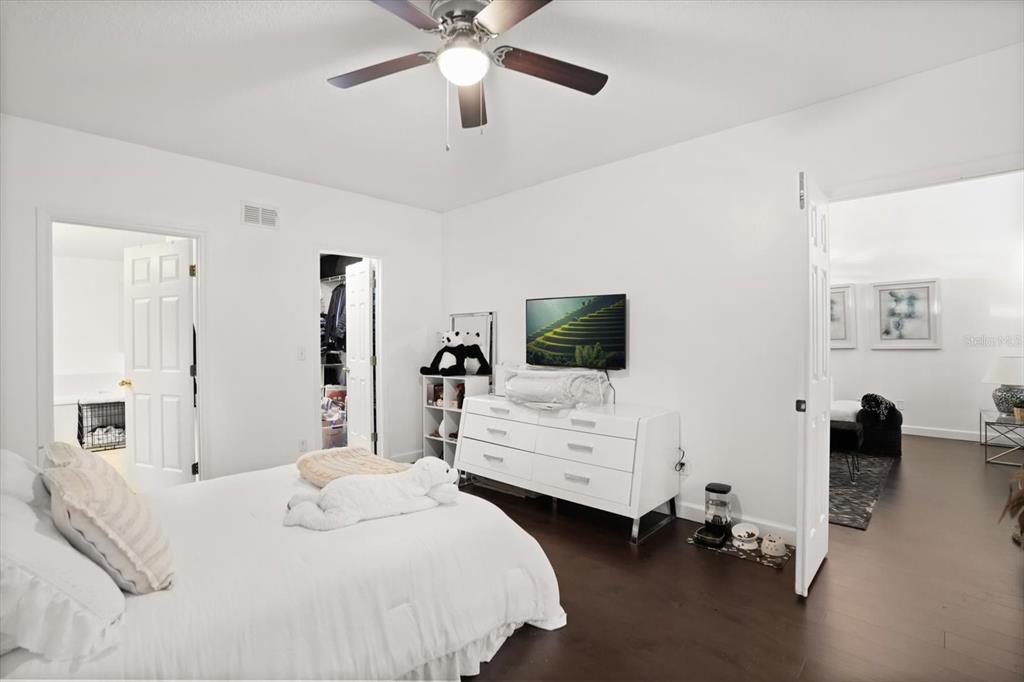 248 Longhirst Loop Ocoee, FL 34761 - Photo 11 of 30 a bedroom with a bed and a flat tv screen