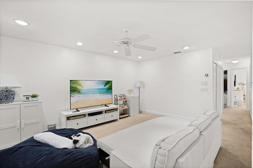 248 Longhirst Loop Ocoee, FL 34761 - Photo 15 of 30 a bedroom with a bed and a flat screen tv