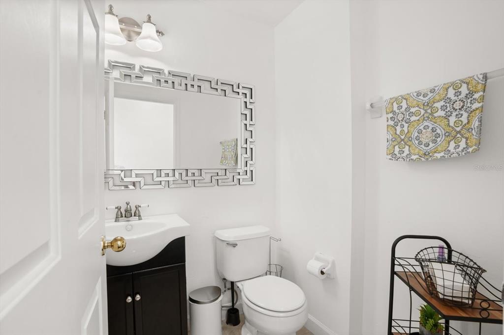 248 Longhirst Loop Ocoee, FL 34761 - Photo 16 of 30 a bathroom with a toilet a sink and mirror