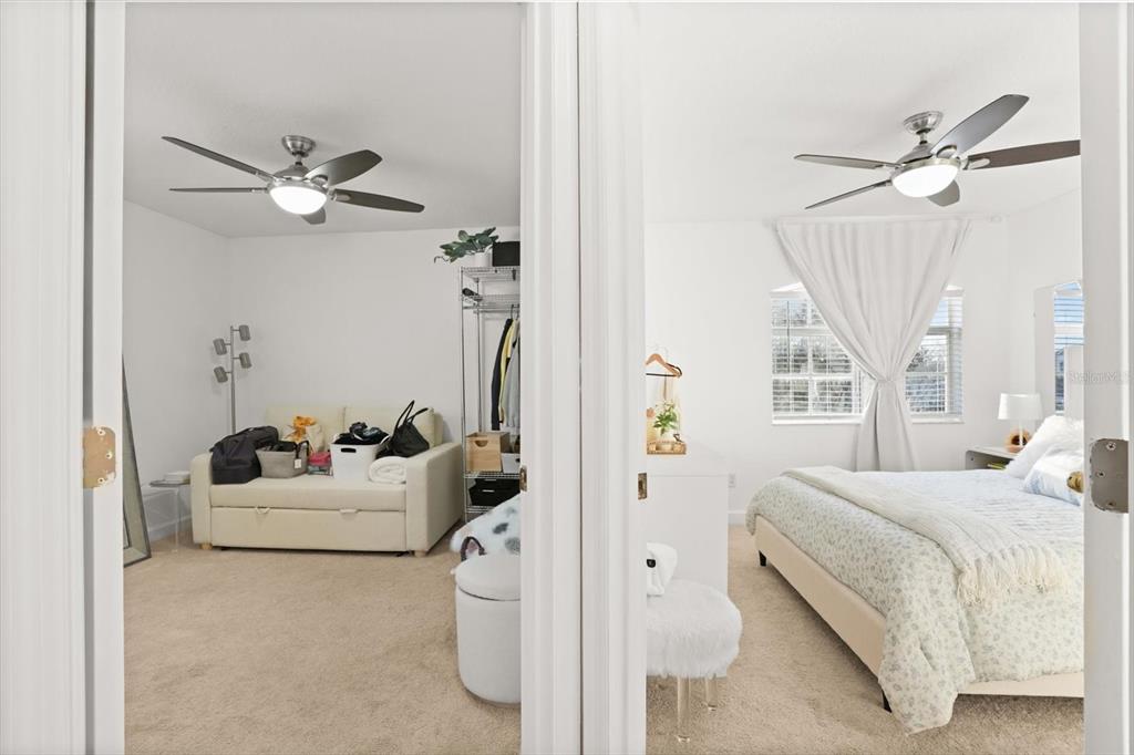 248 Longhirst Loop Ocoee, FL 34761 - Photo 20 of 30 a bedroom with a bed and a chandelier